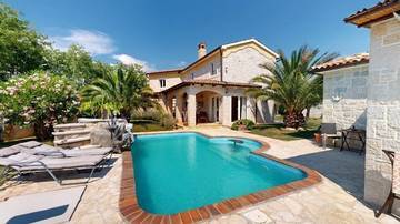 Detached house with a swimming pool, sea view, and a separate konoba in the Mediterranean garden.