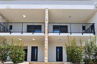 Thumbnail von New garden apartments on a hillside with a view of the water, terraces, and parking space.