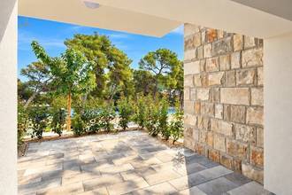 Thumbnail von New garden apartments on a hillside with a view of the water, terraces, and parking space.