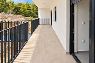 Thumbnail von New garden apartments on a hillside with a view of the water, terraces, and parking space.