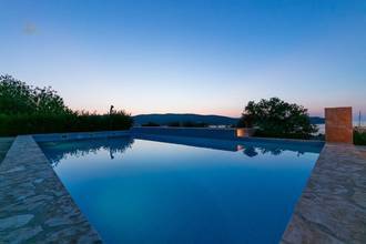 Thumbnail von Four modern units with a shared pool, garden, and water view.