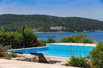 Thumbnail von Four modern units with a shared pool, garden, and water view.