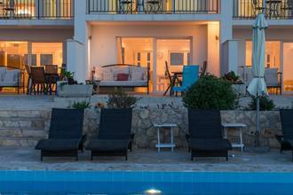 Thumbnail von Four modern units with a shared pool, garden, and water view.